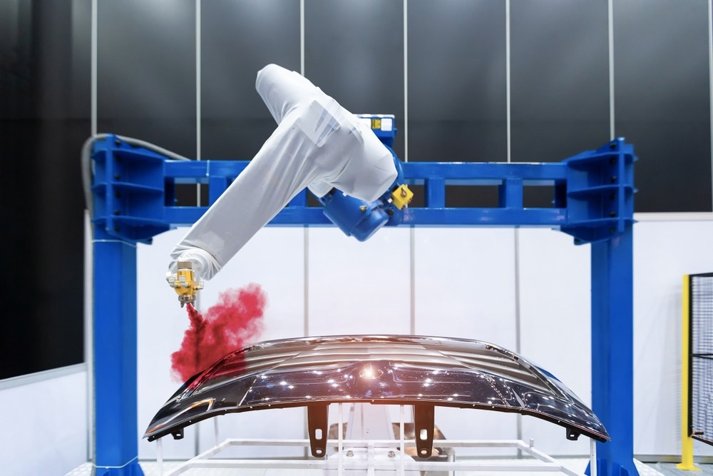 Robotic arm painting spray to the automotive part. High-technology manufacturing concept.